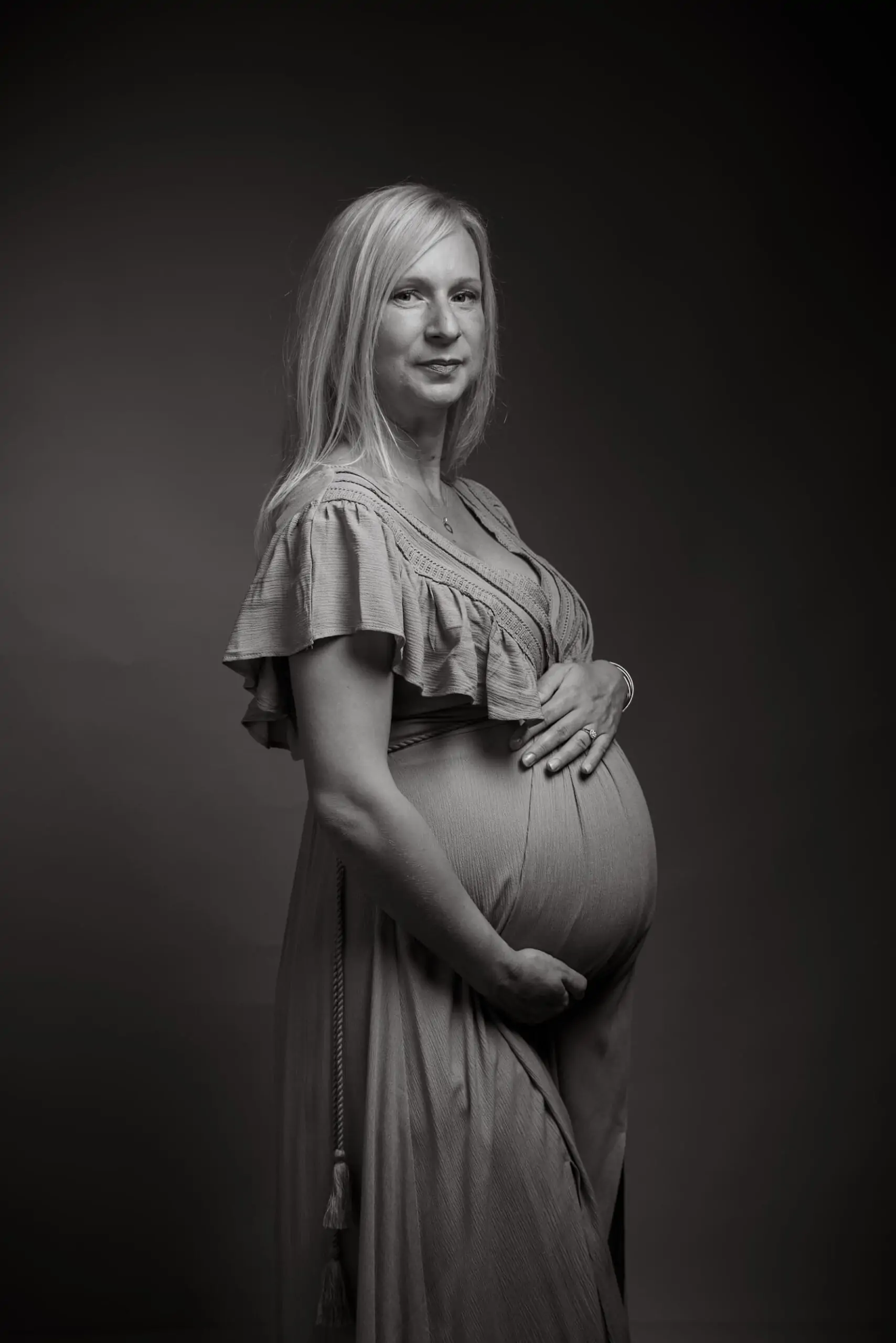 femme enceinte en studio avec une robe photo en noir et blanc